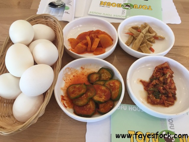 Banchan and raw eggs on each table